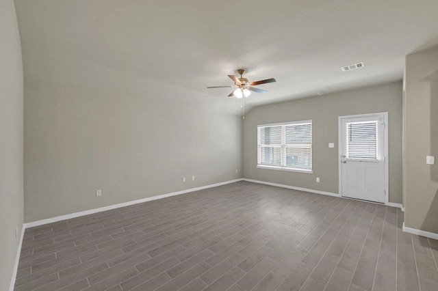 empty room featuring ceiling fan and dark hardwood / wood-style flooring