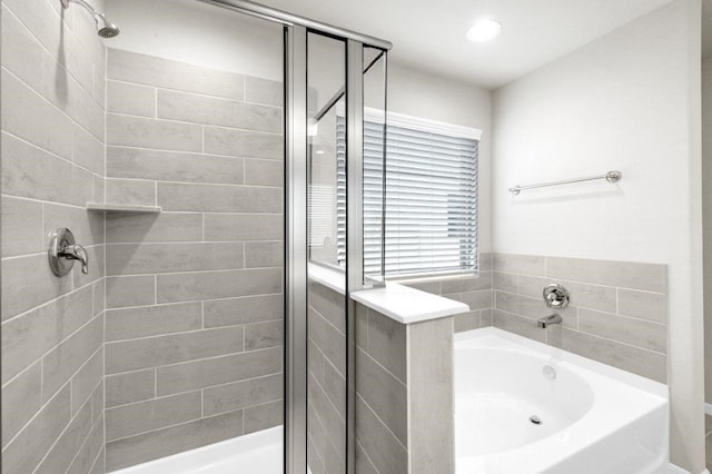 bathroom featuring separate shower and tub