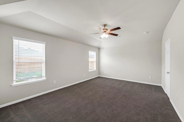 carpeted spare room featuring ceiling fan and lofted ceiling