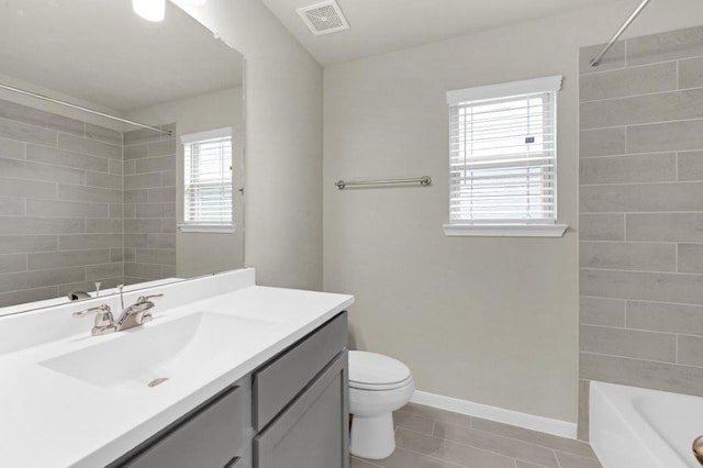 full bathroom with tile patterned flooring, vanity, toilet, and tiled shower / bath combo