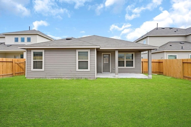 rear view of property featuring a patio area and a yard