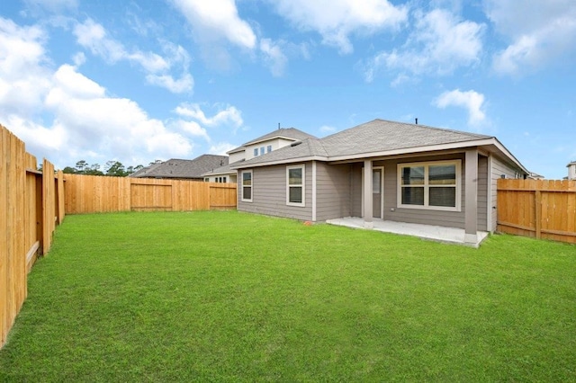 back of property with a patio area and a yard