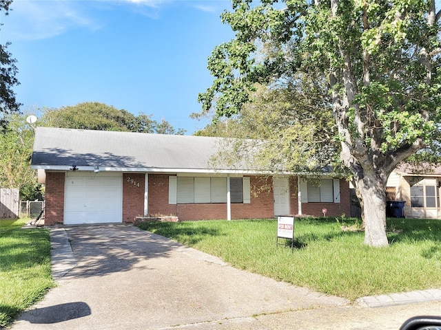 single story home with a front yard and a garage