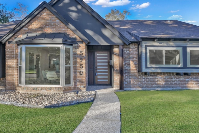 property entrance featuring a lawn