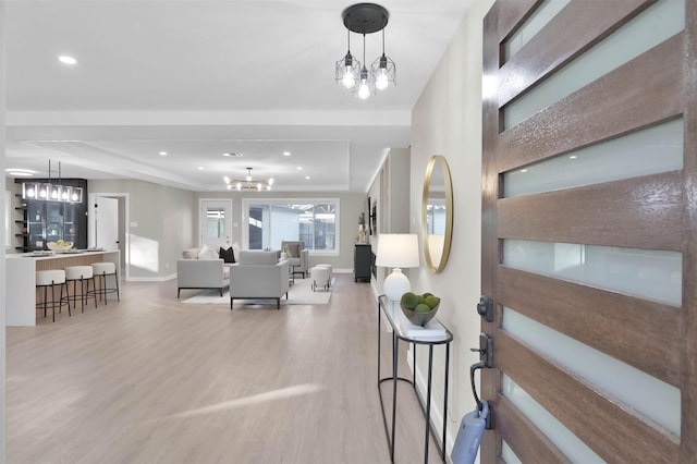 interior space featuring a notable chandelier and light hardwood / wood-style floors