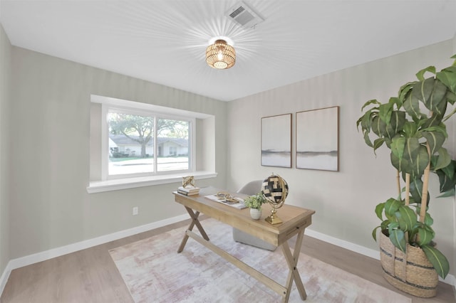 office with light hardwood / wood-style flooring