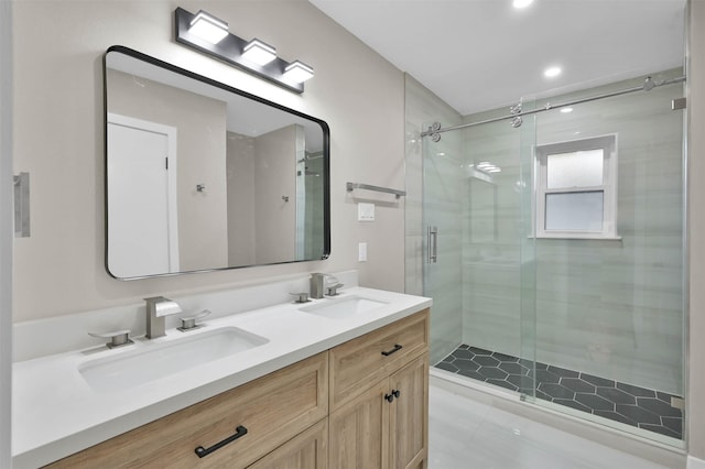 bathroom with vanity and a shower with door