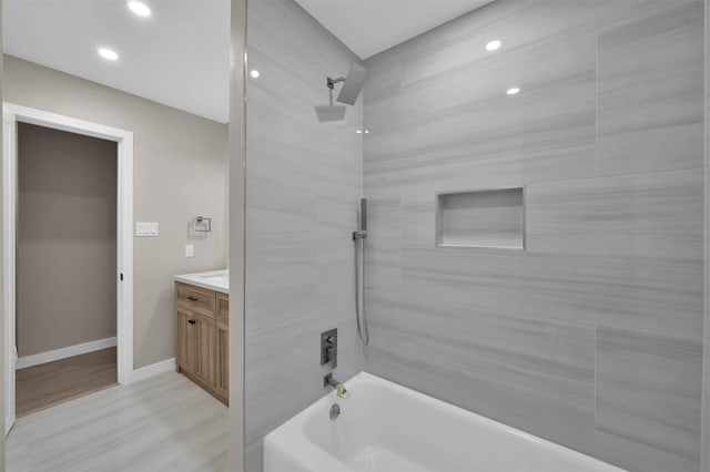 bathroom with vanity, tiled shower / bath combo, and hardwood / wood-style floors