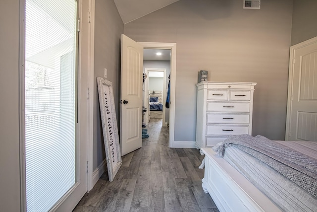 unfurnished bedroom featuring dark wood-type flooring and lofted ceiling