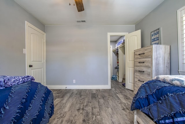 bedroom featuring hardwood / wood-style floors, a closet, and ceiling fan