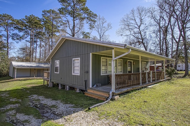 view of home's exterior featuring covered porch and a yard