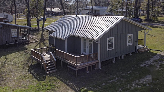 rear view of property with a yard and a deck