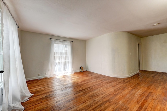 empty room with hardwood / wood-style flooring