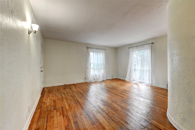 unfurnished room with wood-type flooring