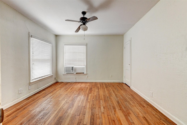 spare room with ceiling fan, light hardwood / wood-style flooring, and cooling unit