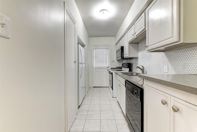 kitchen featuring electric range, dishwasher, tasteful backsplash, white fridge, and light tile patterned floors