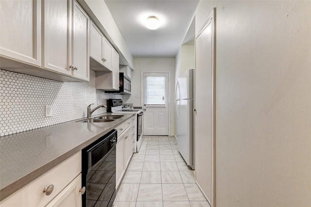 kitchen with tasteful backsplash, white appliances, sink, light tile patterned floors, and white cabinetry