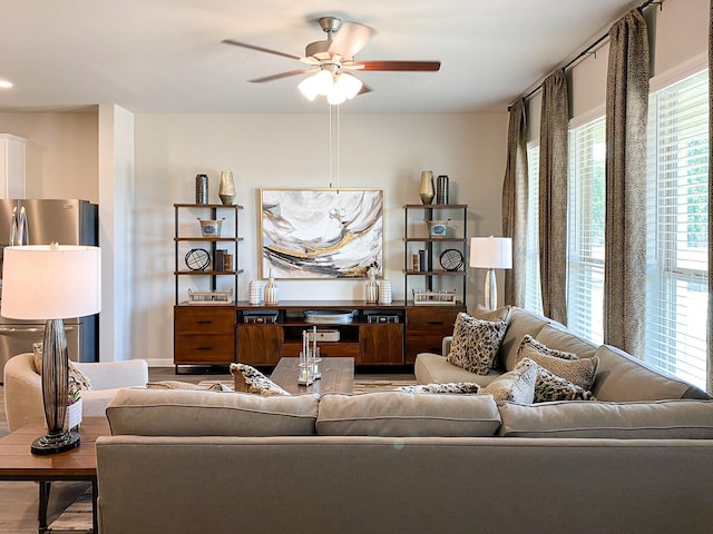 living room featuring ceiling fan and light wood-type flooring