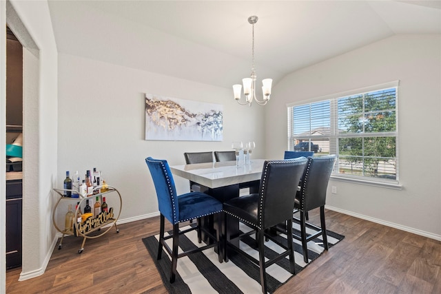 dining area with dark wood-type flooring, lofted ceiling, and a notable chandelier