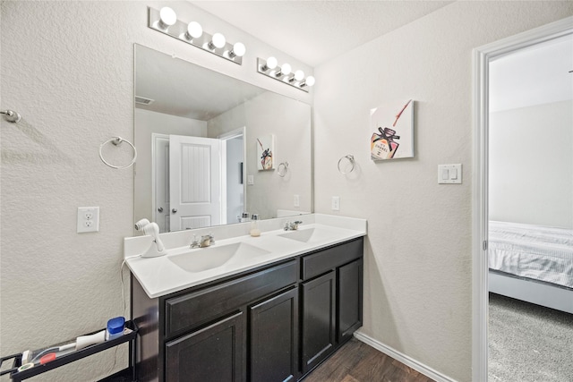 bathroom with vanity, a textured ceiling, and hardwood / wood-style flooring