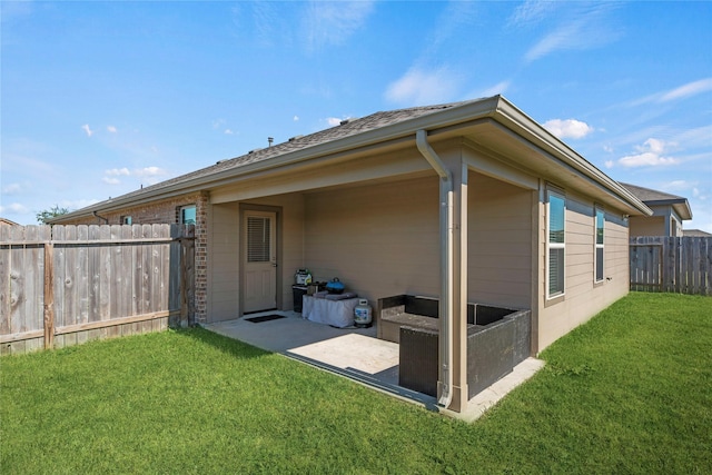 rear view of property with a patio area and a lawn