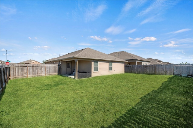 back of property featuring a lawn and a patio