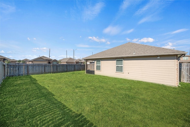 rear view of property featuring a lawn