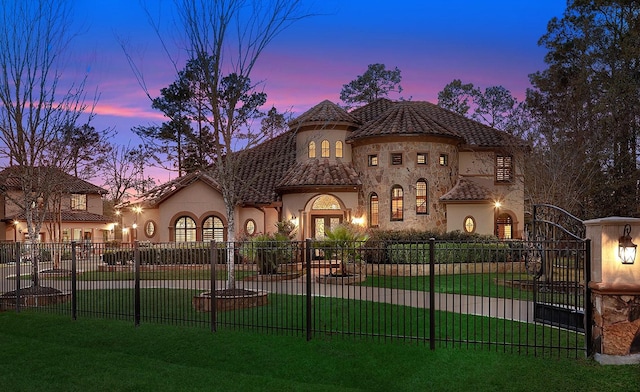 mediterranean / spanish home with french doors and a lawn