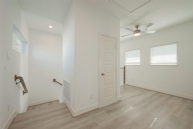 corridor with light hardwood / wood-style flooring