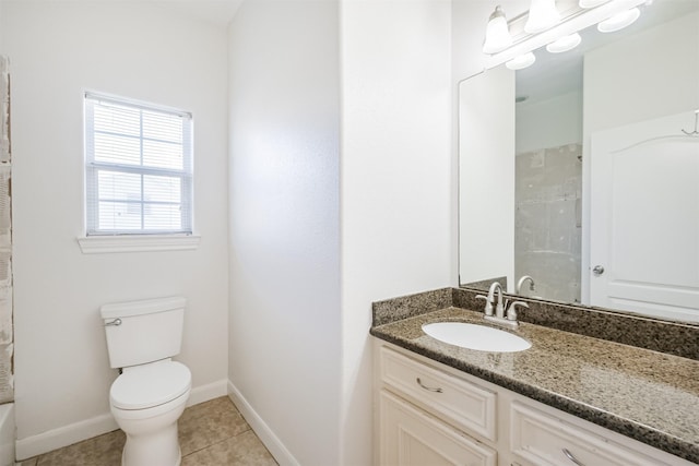 bathroom featuring tile patterned flooring, vanity, toilet, and walk in shower