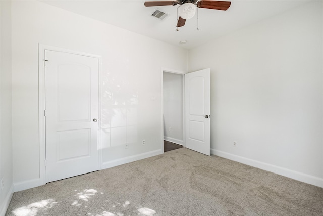 unfurnished bedroom with light colored carpet and ceiling fan