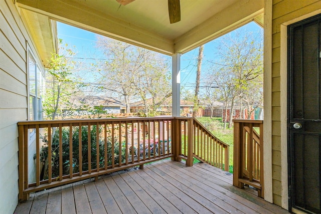 wooden deck featuring ceiling fan