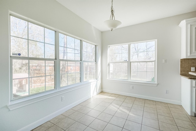 unfurnished dining area with light tile patterned floors