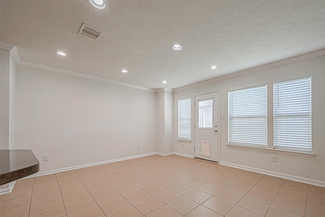 interior space with a textured ceiling and crown molding