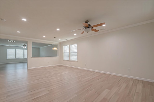 unfurnished room with a healthy amount of sunlight, light wood-type flooring, ceiling fan, and ornamental molding