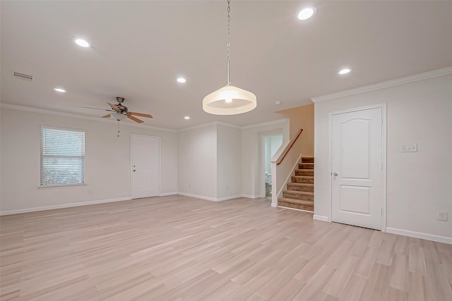 empty room featuring ceiling fan, light hardwood / wood-style floors, and crown molding