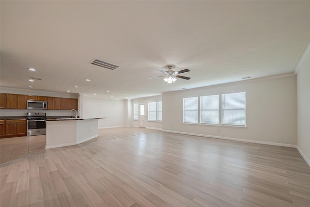 unfurnished living room with ceiling fan, light hardwood / wood-style flooring, sink, and ornamental molding