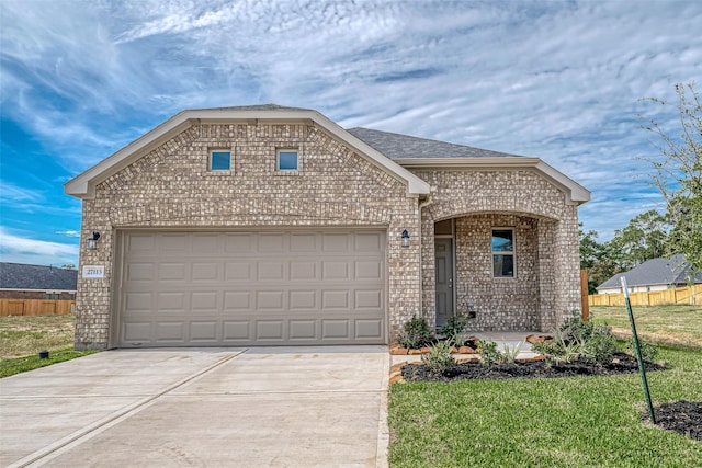 view of front facade with a garage and a front lawn