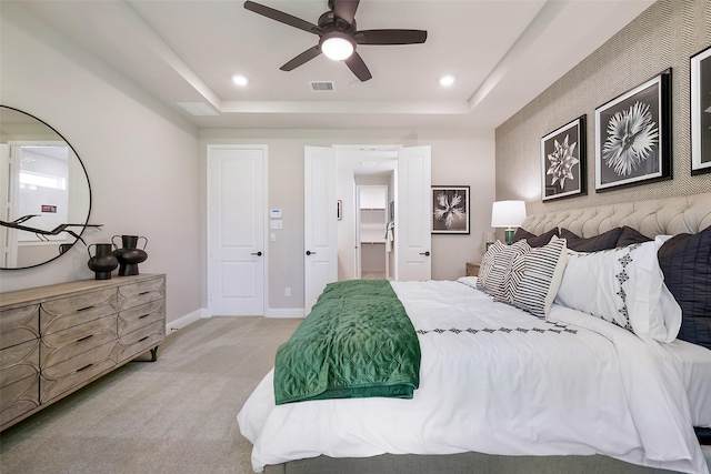 bedroom featuring recessed lighting, a raised ceiling, light colored carpet, visible vents, and baseboards