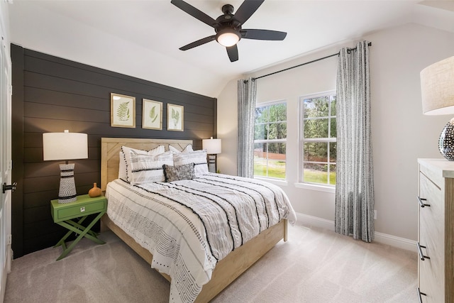 carpeted bedroom with lofted ceiling, a ceiling fan, and baseboards