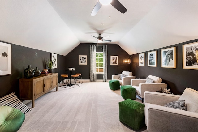 home theater room featuring vaulted ceiling, carpet floors, and a ceiling fan