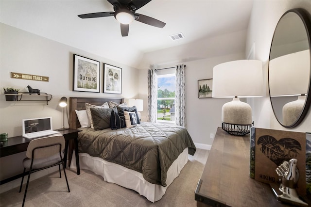 carpeted bedroom with lofted ceiling, a ceiling fan, visible vents, and baseboards