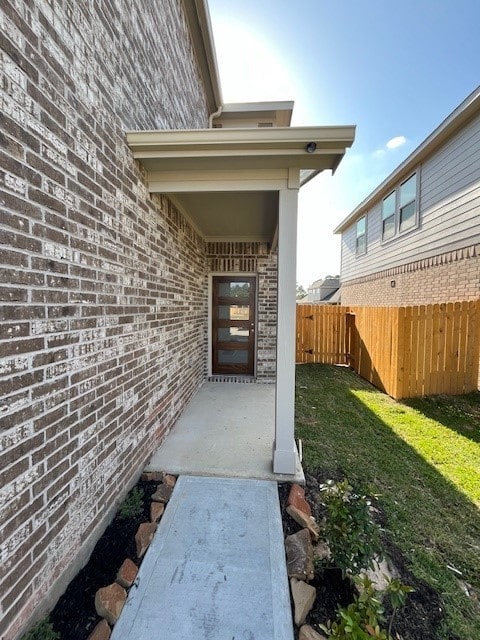 property entrance with a lawn