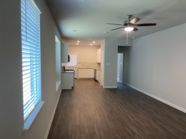 unfurnished living room featuring dark hardwood / wood-style floors and ceiling fan