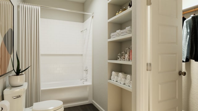 bathroom with shower / tub combination, built in features, and toilet