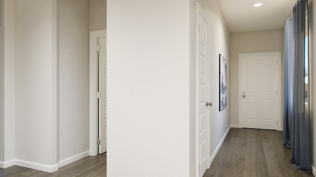 hallway with dark hardwood / wood-style floors