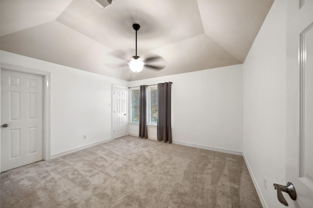 unfurnished bedroom featuring ceiling fan, light carpet, and vaulted ceiling