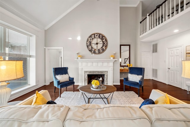 living room with crown molding, high vaulted ceiling, and dark wood-type flooring