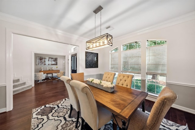 dining area with dark hardwood / wood-style floors and crown molding