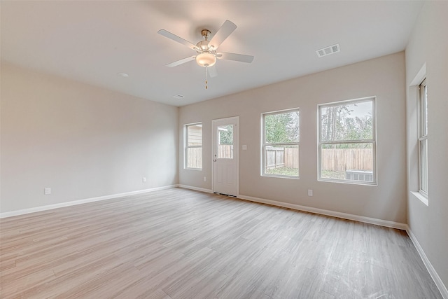 empty room with light hardwood / wood-style floors and ceiling fan